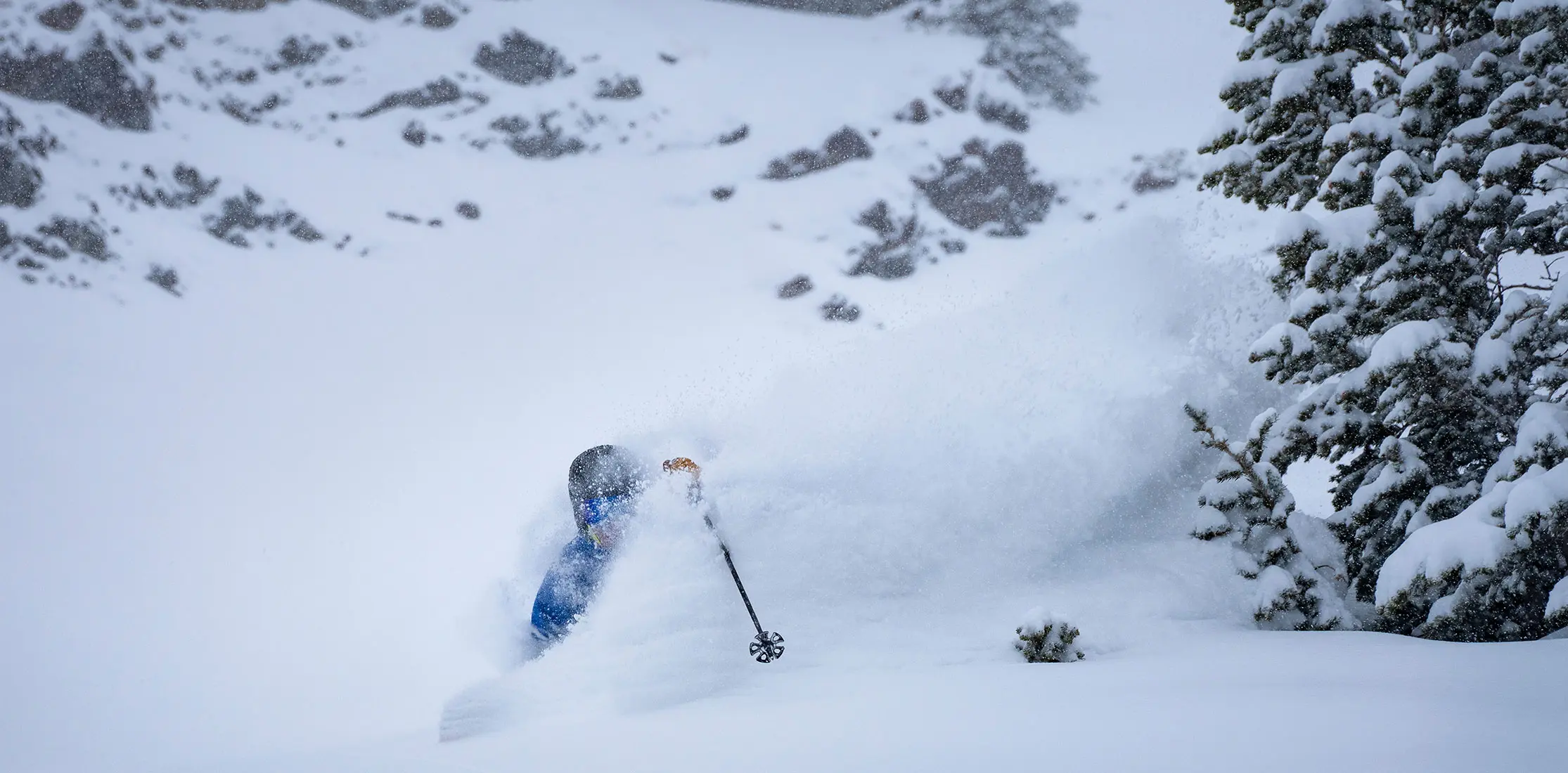 Skier in deep powder, pole sticking out during the april storm at Snowbird
