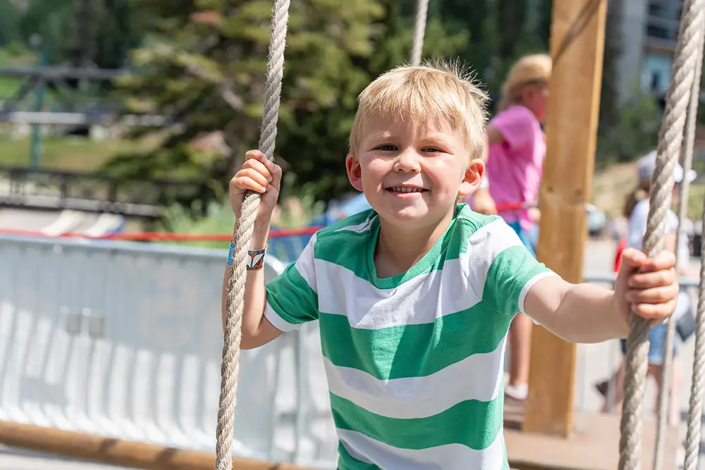 Kid exploring the mini ropes course at Snowbird