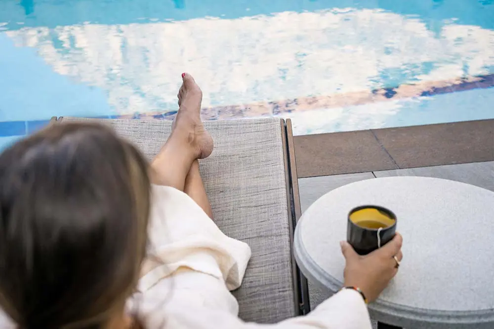 Relaxing by The Cliff Spa's rooftop pool with tea