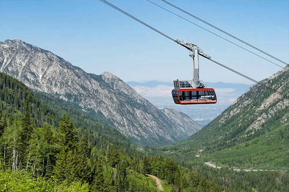 Red tram with balcony at snowbird during the summer