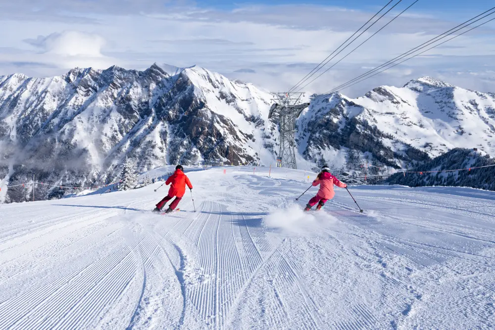 2 skiers with Mt. Superior in the background