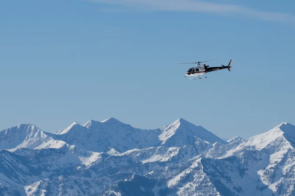 Winter scenic helicopter tour, a helicopter above the snowy mountains