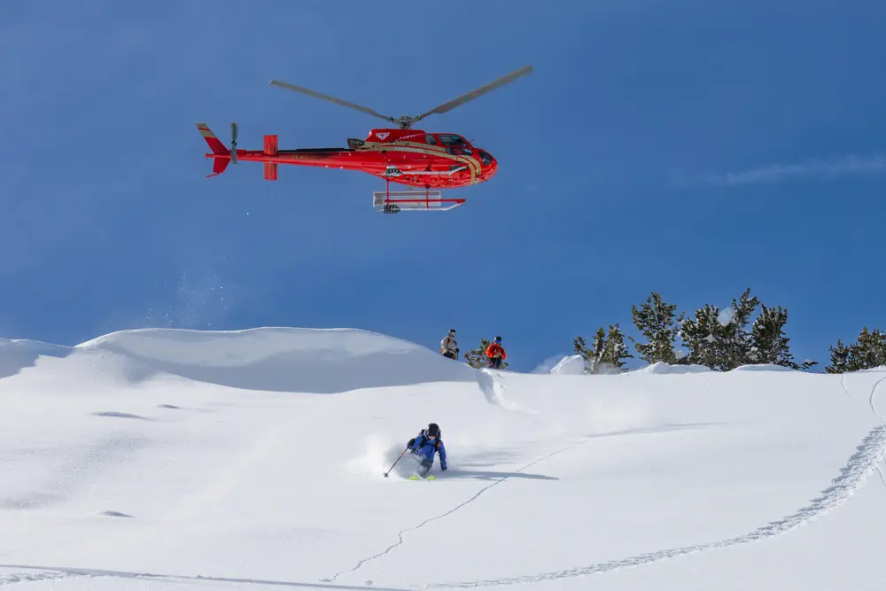 Powderbird skiing near Snowbird, skier under helicopter