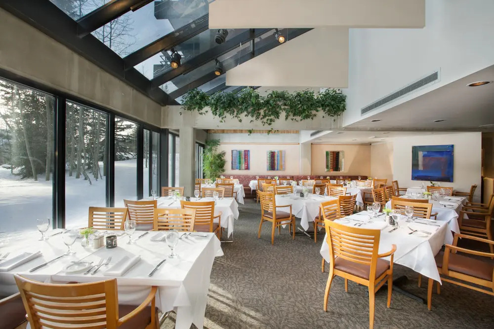 Wildflower dining tables next to a snowy window