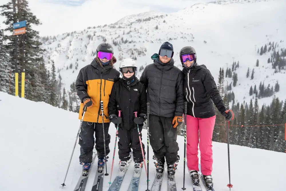 Family poses while skiing and smiling. Family groups are one of the leisure groups Snowbird accommodates.