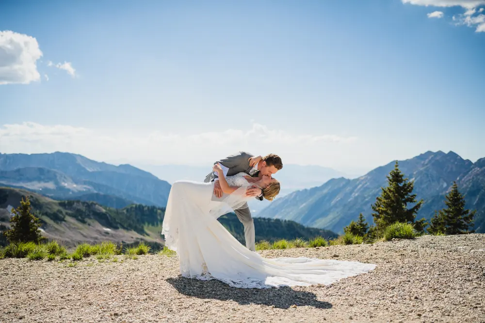 Couple kisses at the Summit Wedding venue during summer with Canyon views