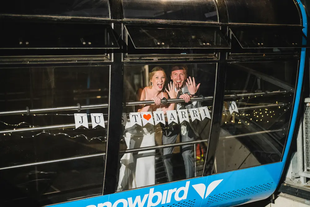 Couple in the aerial tram at Snowbird with a "Just Married" sign