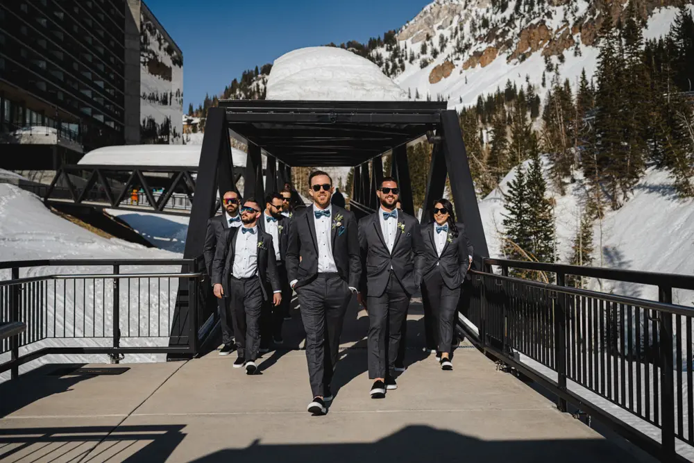 Groomsmen walking on the pedestrian bridge at Snowbird