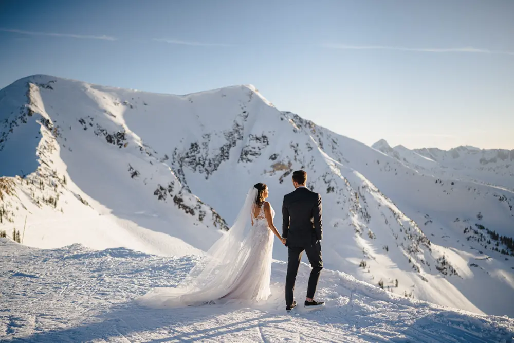 Couple admiring the snow-covered view from the Summit Wedding venue