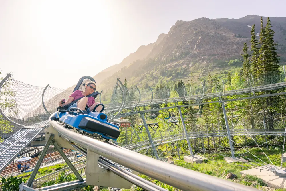Adult on the Mountain Coaster at a company retreat at Snowbird