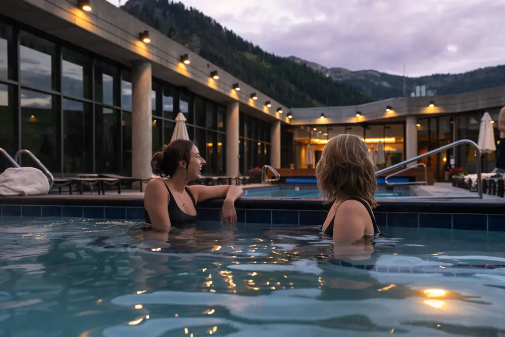 2 women sit in the hot tub at The Cliff Spa at Snowbird during a corporate event
