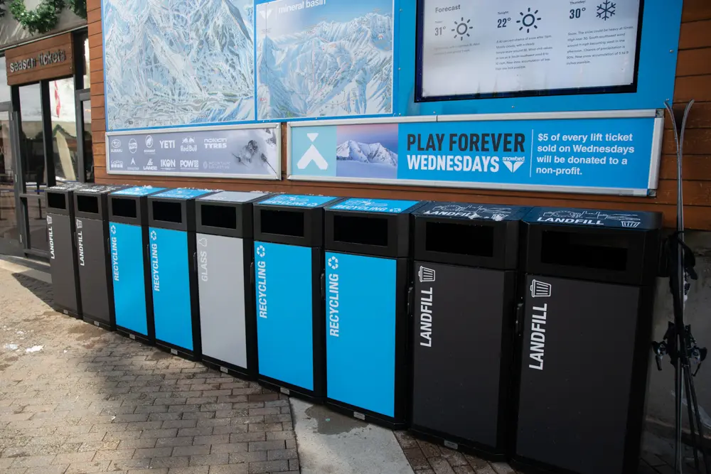 Trash cans, recycling bins and compost bins lined up at Snowbird
