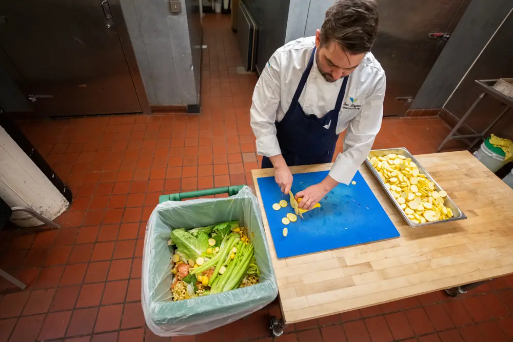 Chef cuts food and composts unusable parts