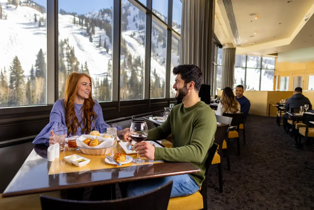 Couple enjoying dinner at The Aerie at Snowbird during a corporate event