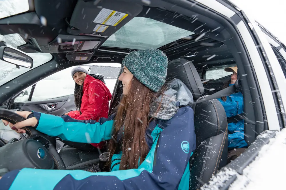 Group of skiers gets out of a car after carpooling to Snowbird