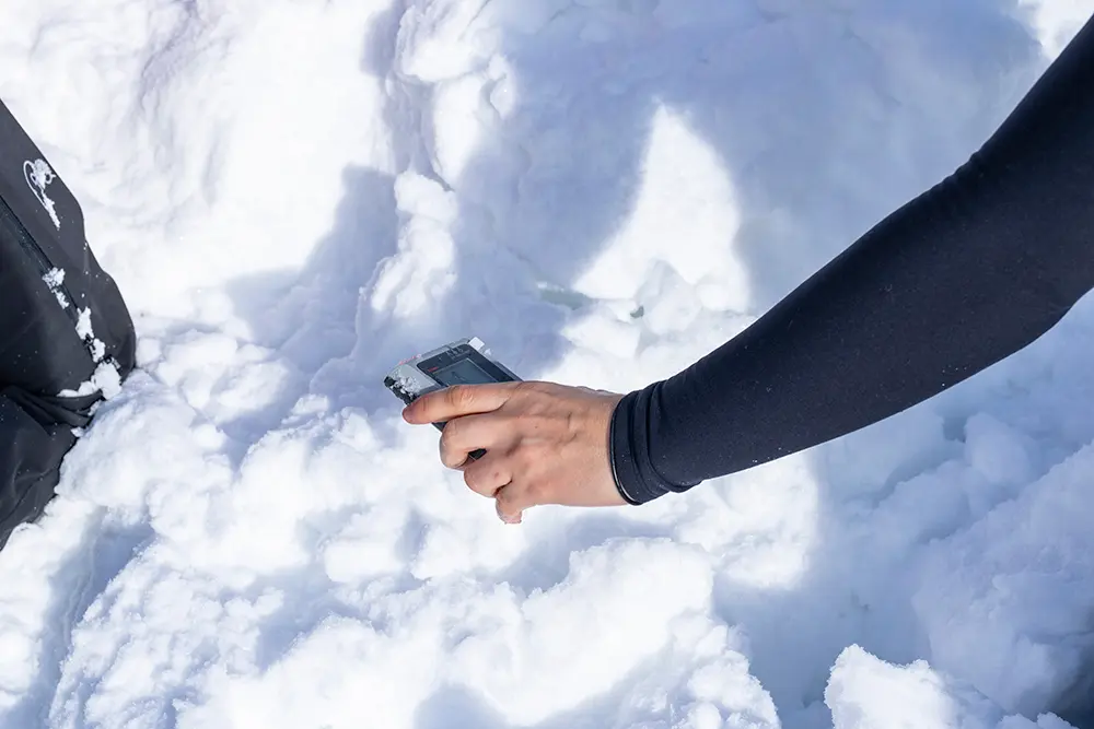 Using a beacon to practice Avalanche Safety during the AIARE 2 course at Snowbird