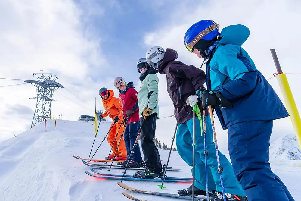 Family standing near silver fox at Snowbird, talking and smiling