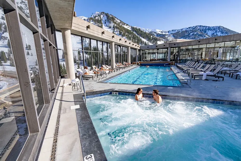 Couple sits in the hot tub at the Cliff Spa during the winter