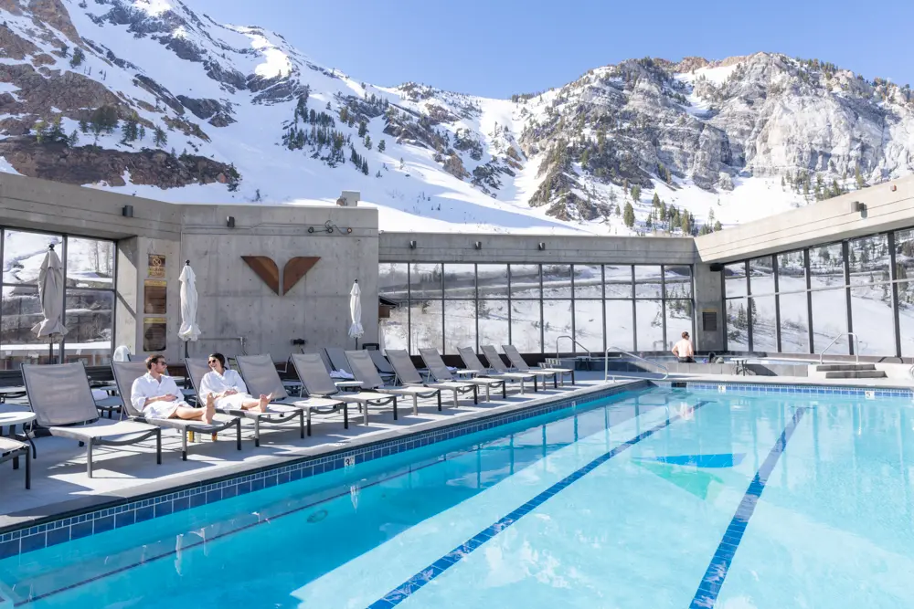 A couple relaxes at Snowbird next to the rooftop pool