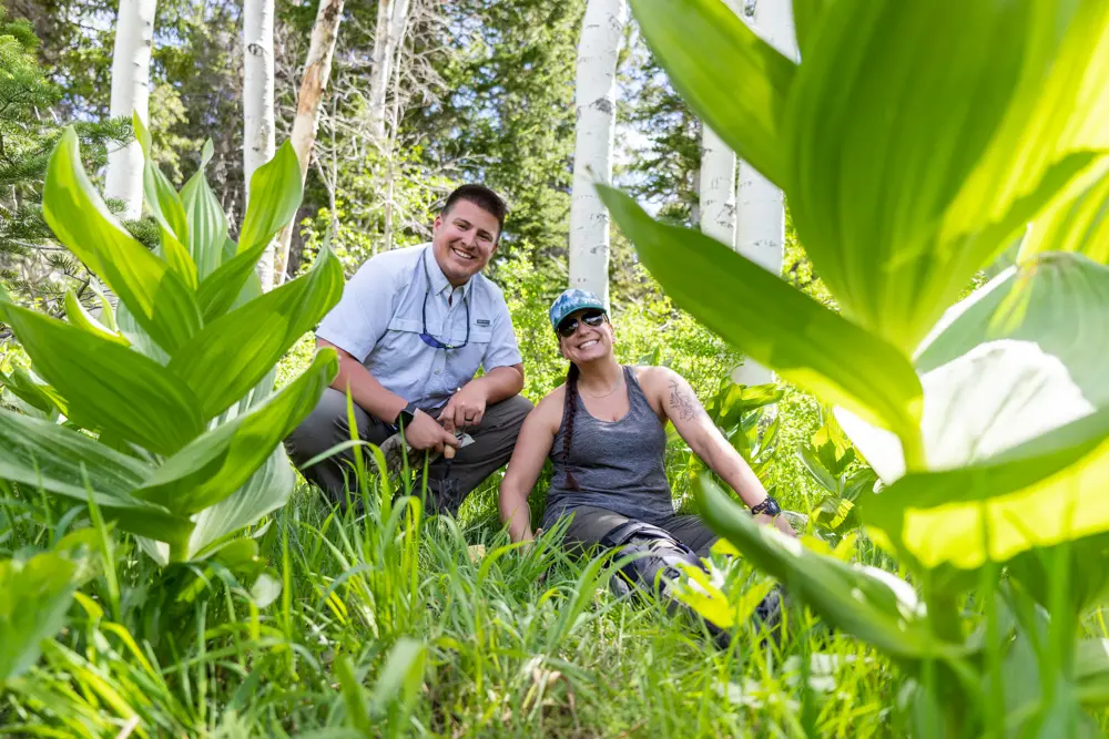 Snowbird employees pose and smile during a weed pull event