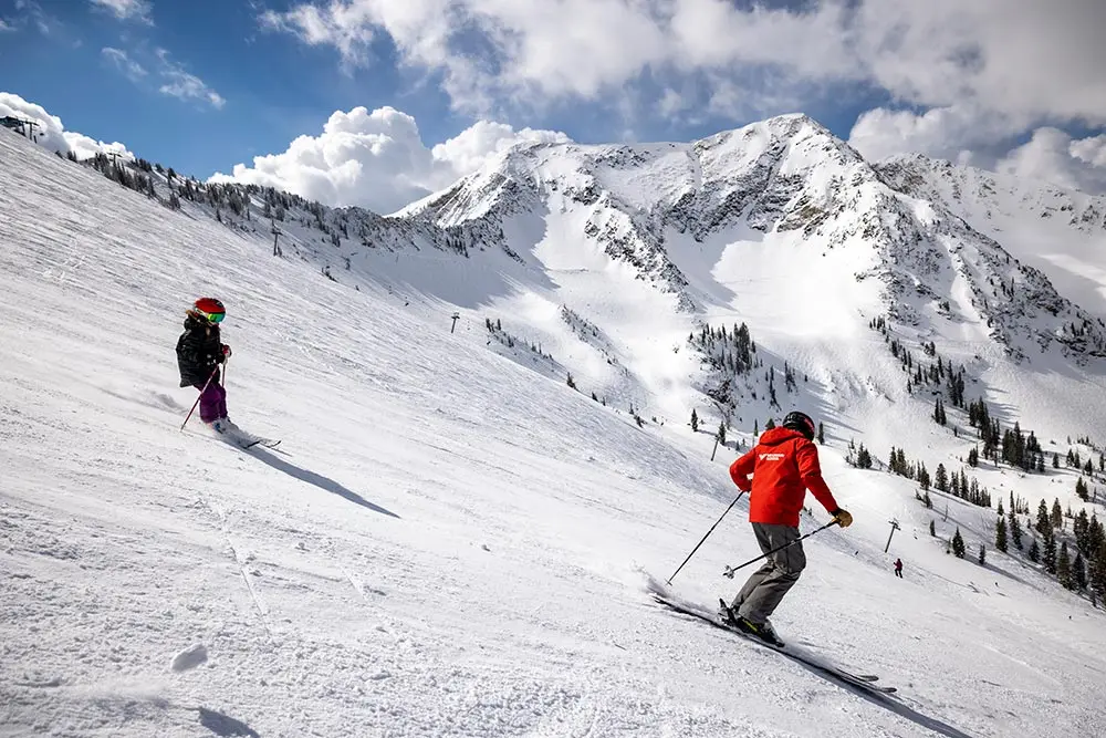 Instructor guides a kid doing the holiday camp at Snowbird