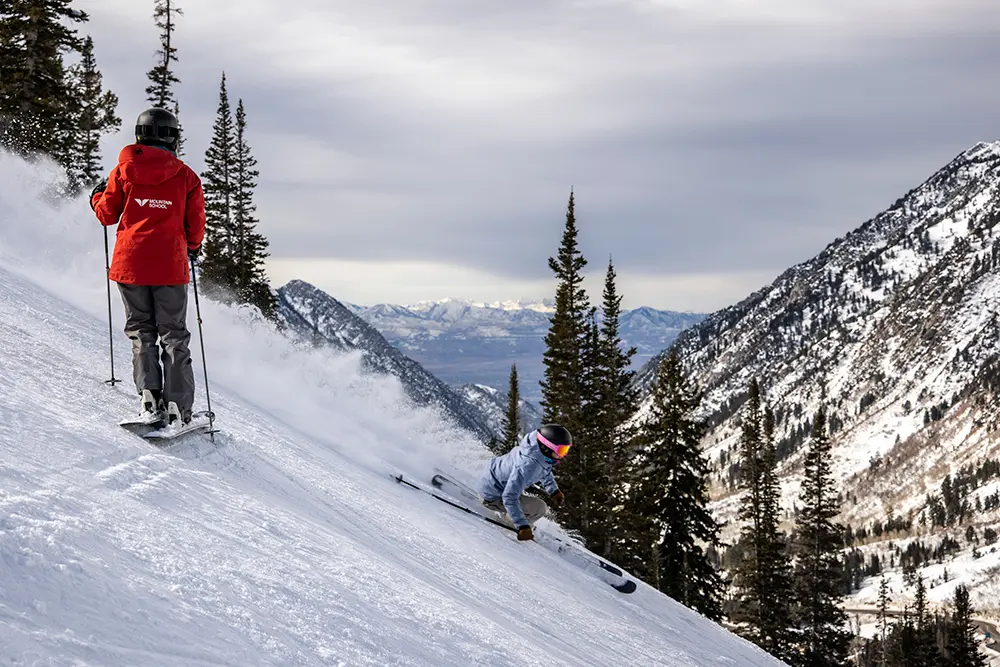 Snowbird instructor watches as woman skis during Snowbird's Women's Camp