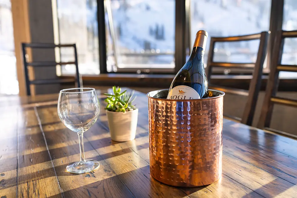 Inside the Powderbird heliport, chilled wine and a glass