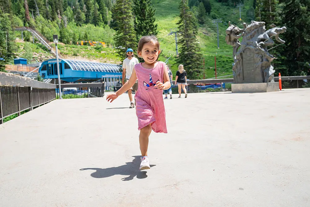 Kid runs around on the Plaza Deck at Snowbird