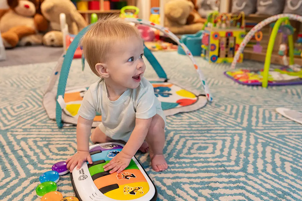 Kid playing the toy piano at Superior Childcare