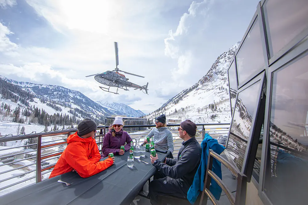 Apres on the Powderbird Heliport deck with helicopter in the background