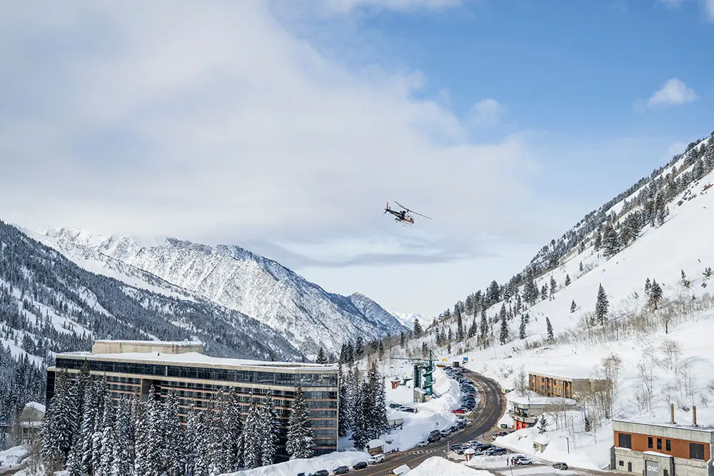 Helicopter flys above the Cliff Lodge during the Silver Package with Powderbird