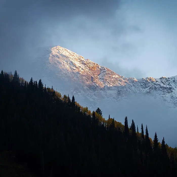 Play Forever mobile hero - mountain with snow in fall with hint of colored leaves