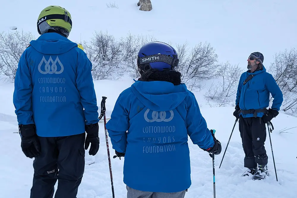 Cottonwood Canyons volunteers talk to guests on a Ski with a Ranger Tour at Snowbird