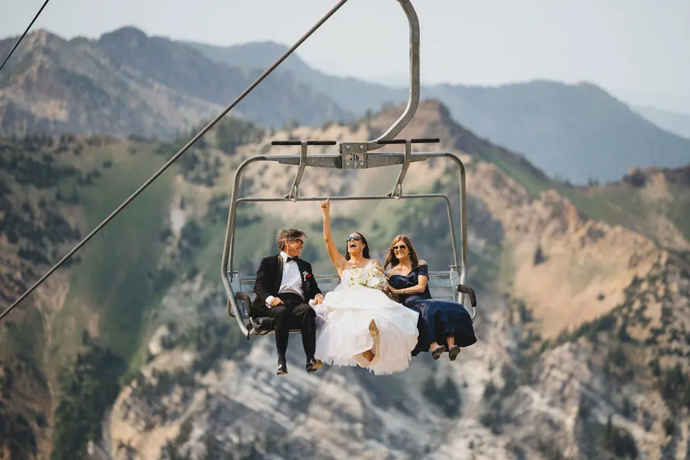 Bride on chairlift at Snowbird during her wedding