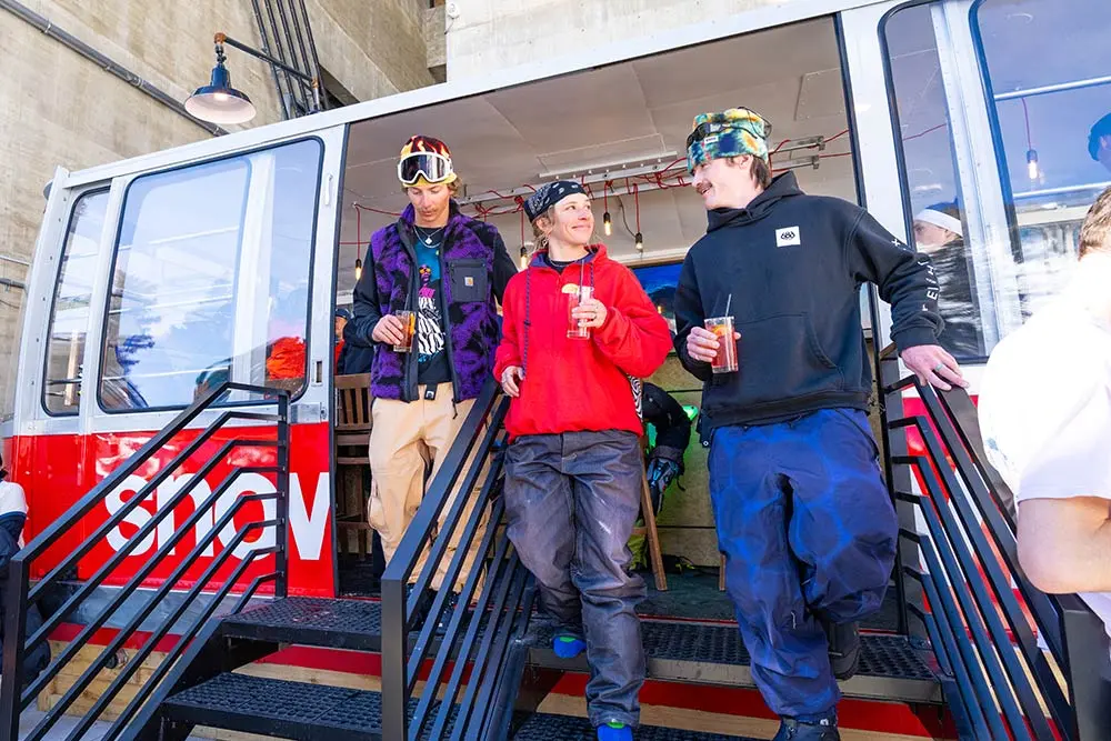 Group of people walk out of the Tram Bar at Snowbird