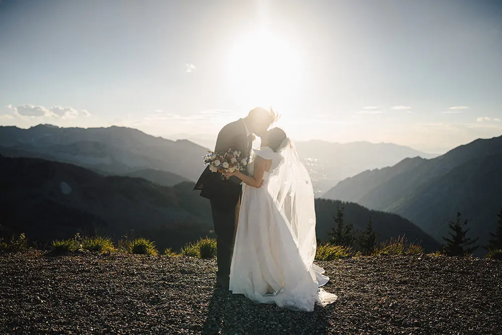 Couple kisses at the Summit during a Snowbird Wedding, one of Utah's premier outdoor wedding venues