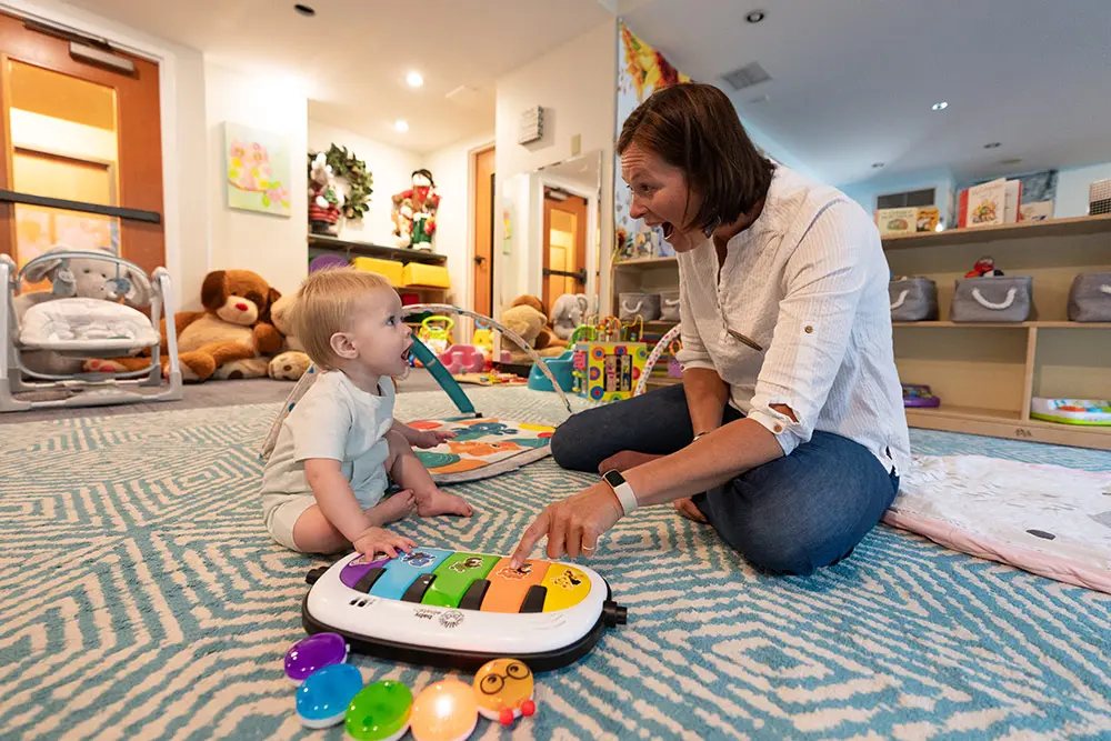 Superior Childcare - a child plays with toys with a teacher