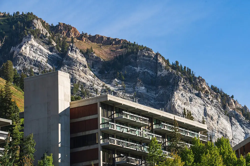 The outside of The Inn at Snowbird, under the hellgate cliffs, in the summer. One of the popular lodging options at Snowbird