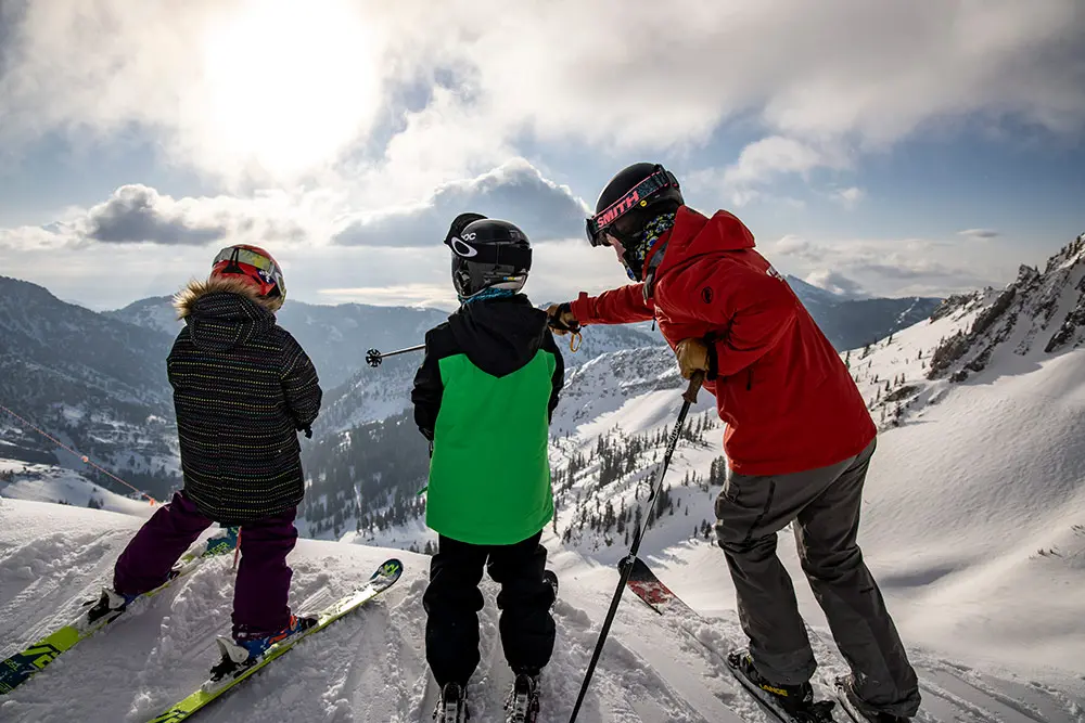 a Mountain School employee points to the steeps at Snowbird on a Youth Ski Lesson