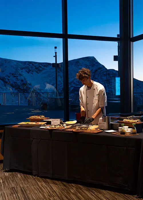 Chef at a serving table at a Snowbird event- request your own event - mobile hero