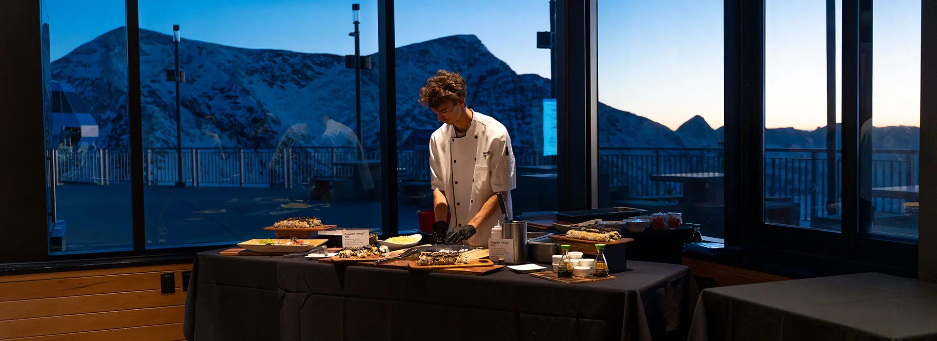 Chef at a station during the full moon dinner at Snowbird, you can request your own event at Snowbird for either a wedding, business or family
