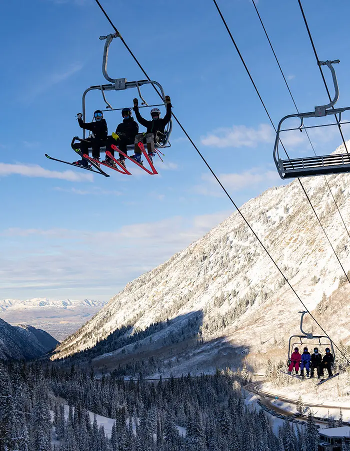 Mobile hero of kids cheering on a lift during opening day at Snowbird