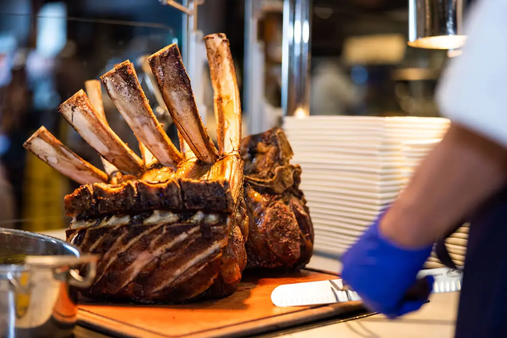Carving station at Snowbird's christmas eve feast, featuring bone-in ribeye steak.