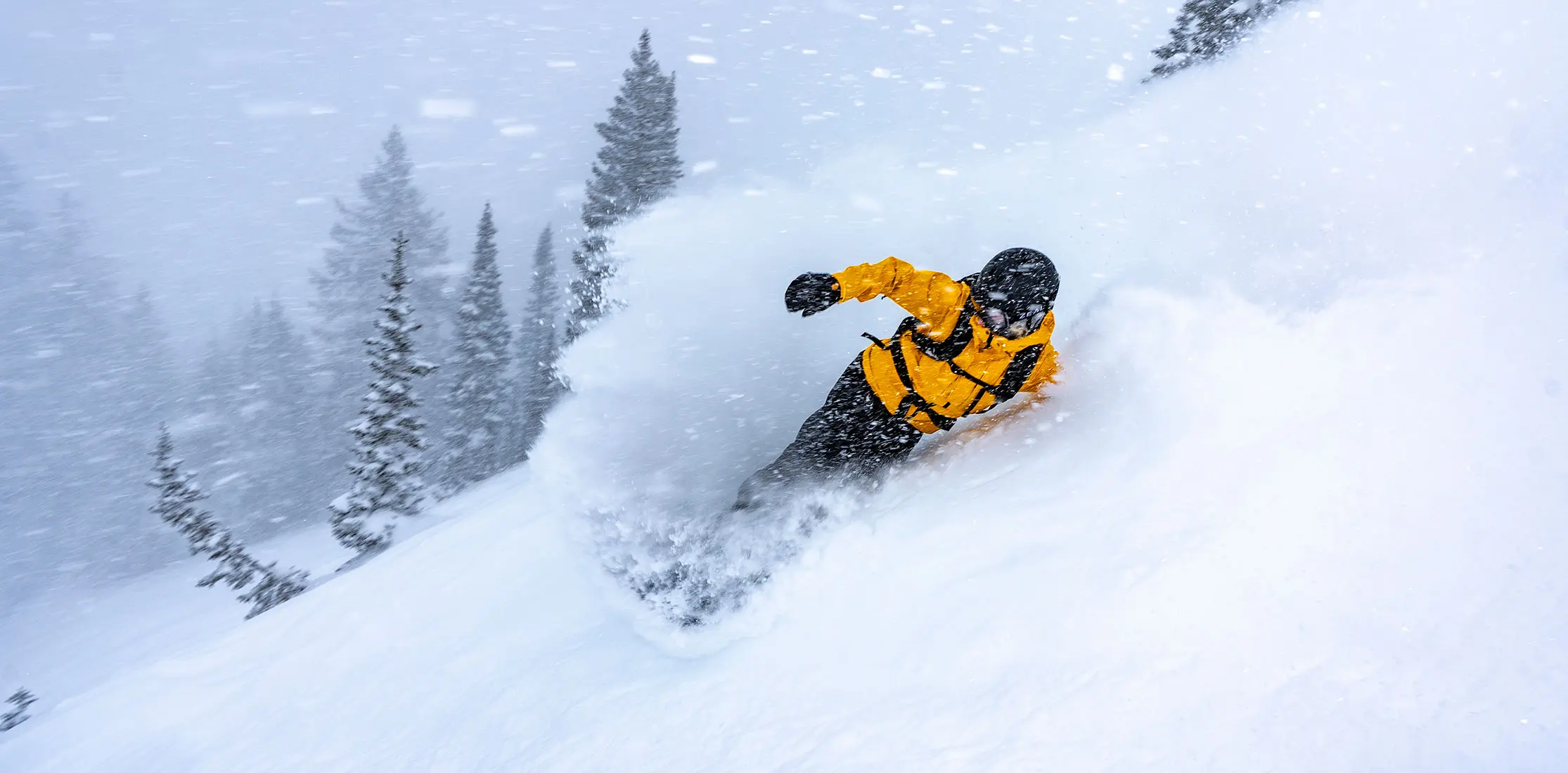 Snowboarder in deep powder during the February storm at Snowbird