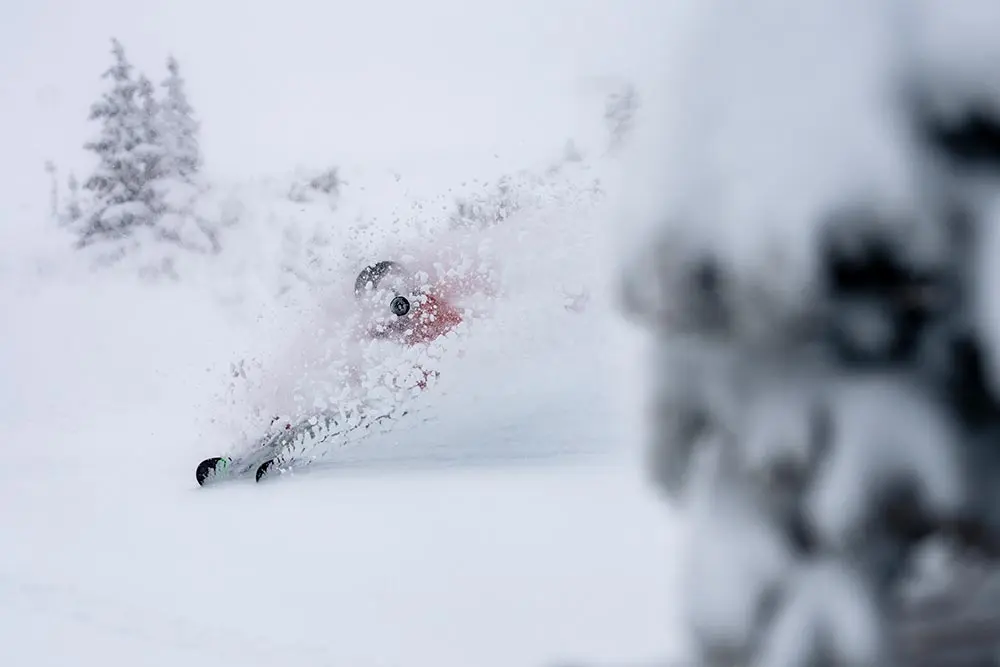 Skier slashes through snow during a January storm at Snowbird