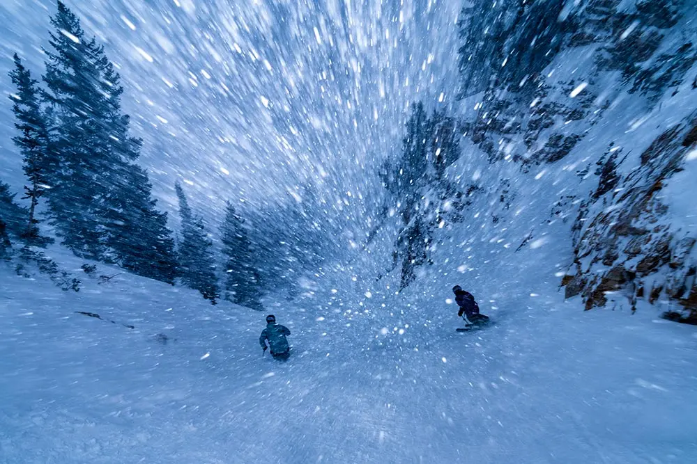 Group skiing in a storm at Snowbird