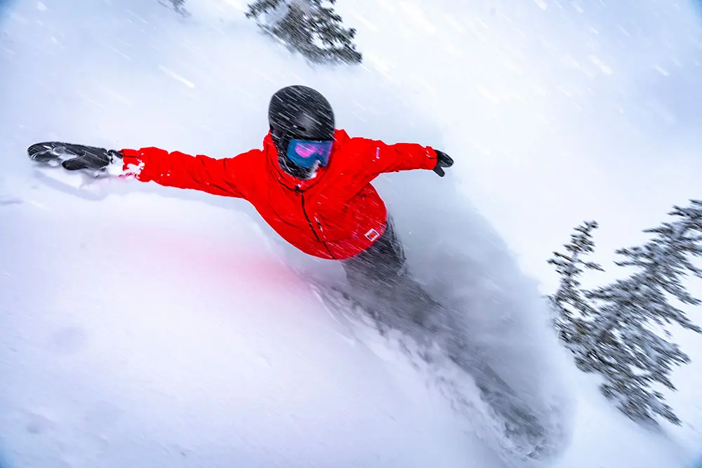 Flash photo of snowboarder in a storm at Snowbird