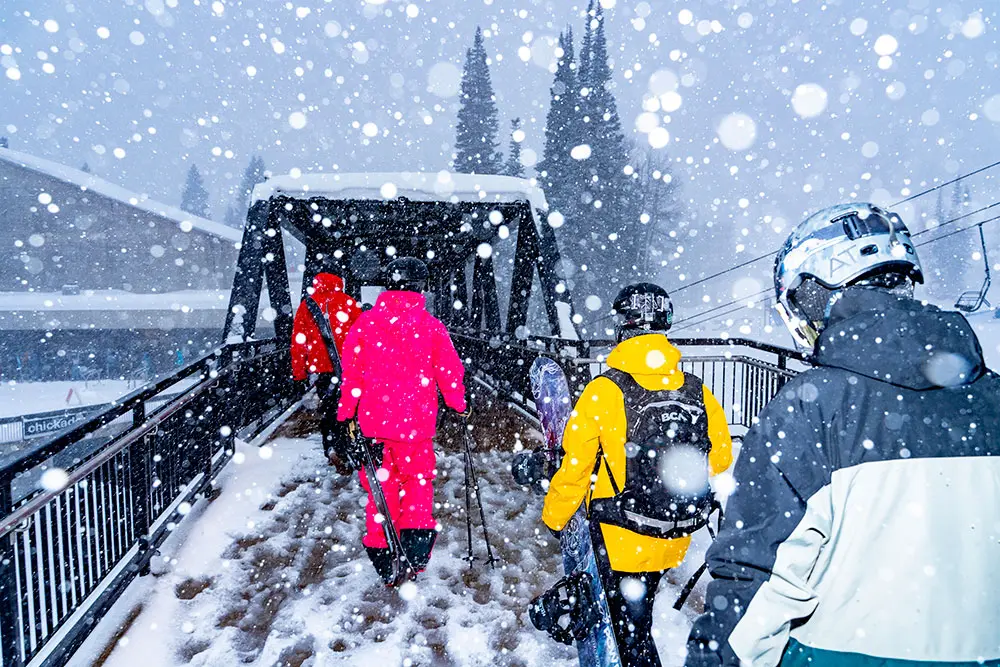 group walks on the bridge towards the Snowbird Center