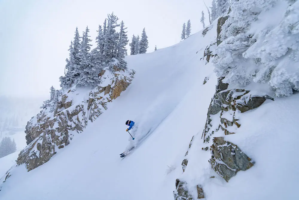 Skier in a rock-wall chute at Snowbird with the Alta-Bird Season Pass