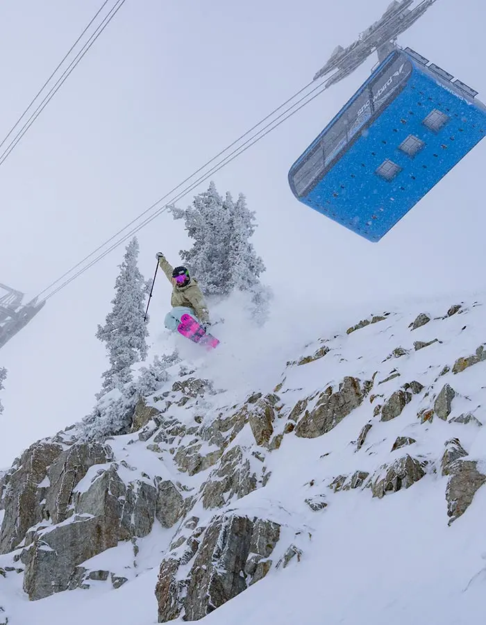 Season Pass hero, mobile- Skier hits a cliff under the blue tram at Snowbird